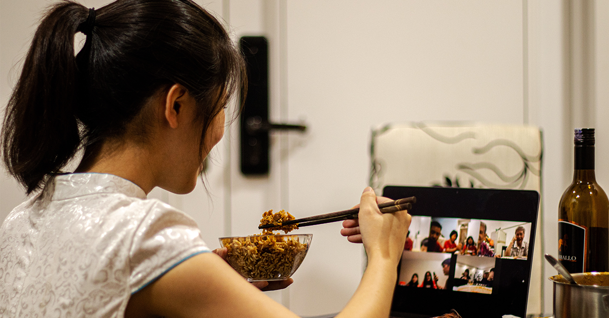 asian girl eating while on zoom meeting