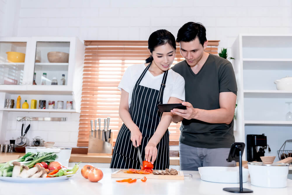 8-simple-ways-save-money-when-renting-condo-cooking-kitchen-couple