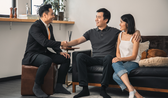 Asian property agent shaking hands after completing the HDB resale transaction